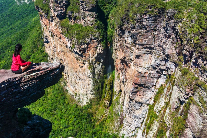 Woman at the edge of a cliff in Vale do Pati (Paty Valley), Chapada Diamantina National Park, Bahia, Brazil