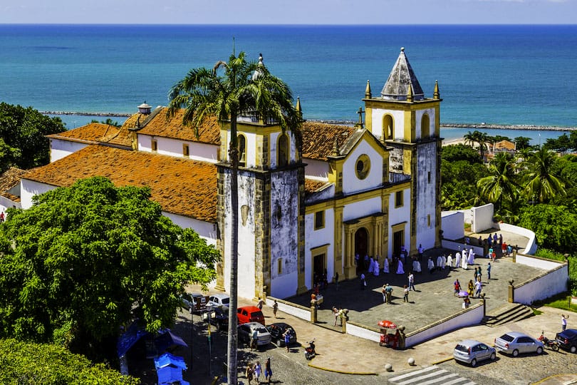 OLINDA, BRAZIL - MAY 1: Aerial view of Olinda in PE, Brazil showcasing its historic architecture with the Baroque Se Church after a service with priests and locals passing by on May 1, 2015 in Olinda.