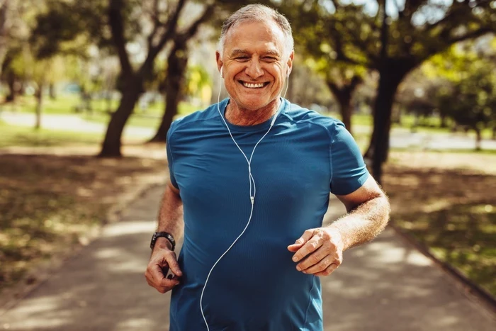 03 portrait of a senior man in fitness wear running in a park