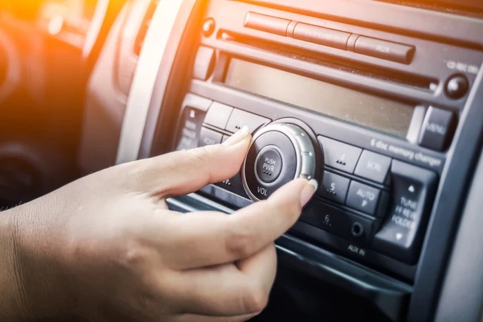 02 woman tuning radio in car
